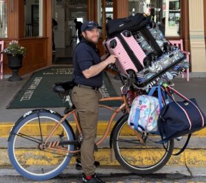 our dock porter bringing luggage in his bike down to the ferry dock