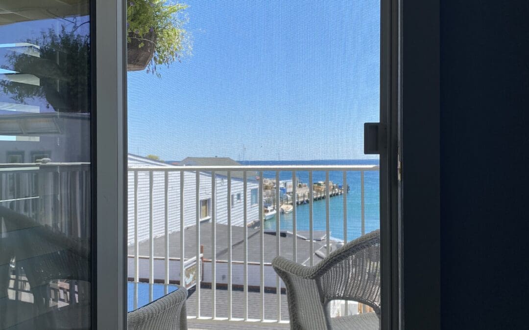 a balcony at the Lilac Tree Suites with 2 chairs and a table looking out towards Main Street and the lake