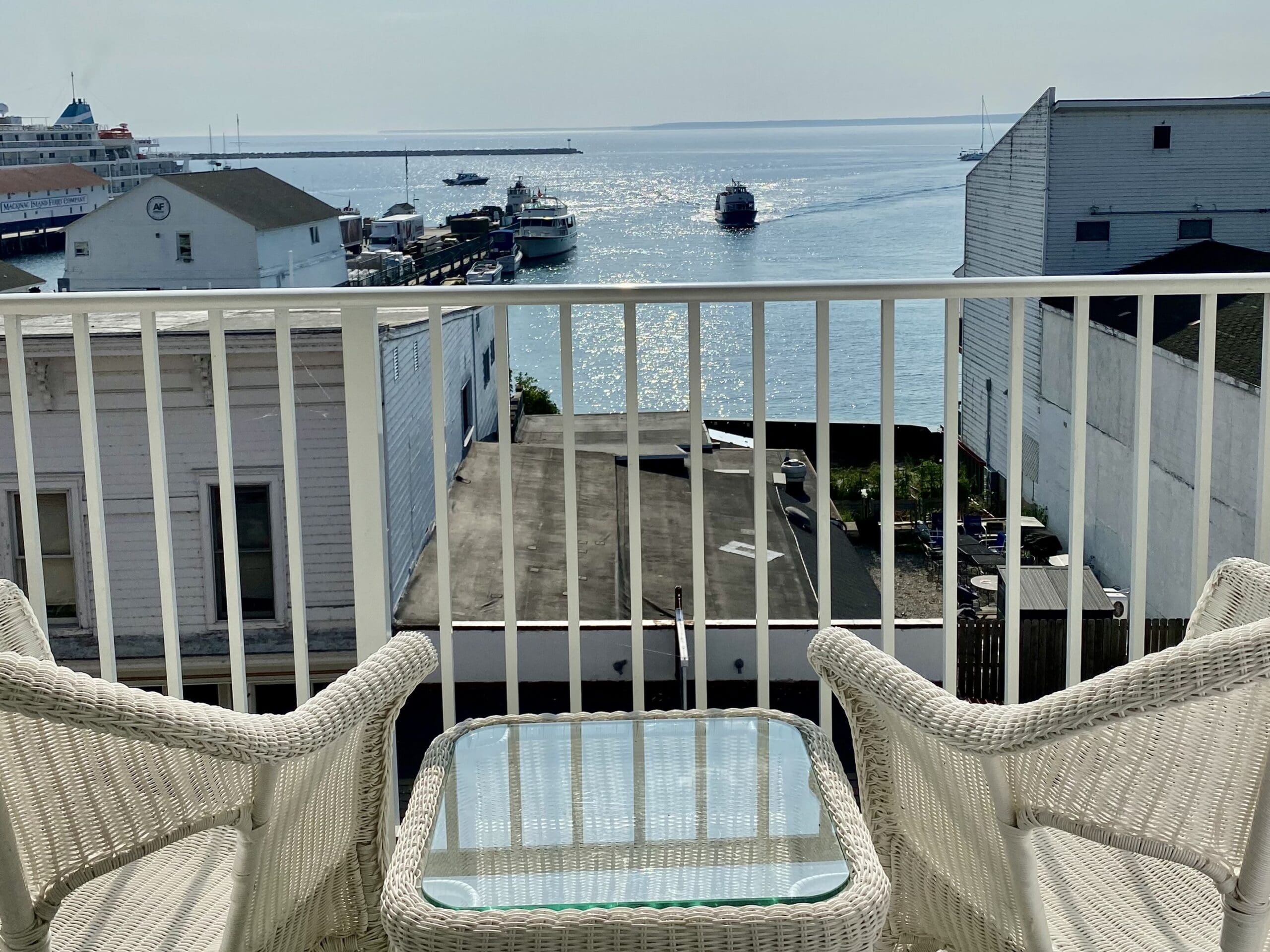 chairs on a balcony of the lilac tree hotel looking over the street showing peak season